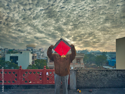 Man holding a kite over his head photo