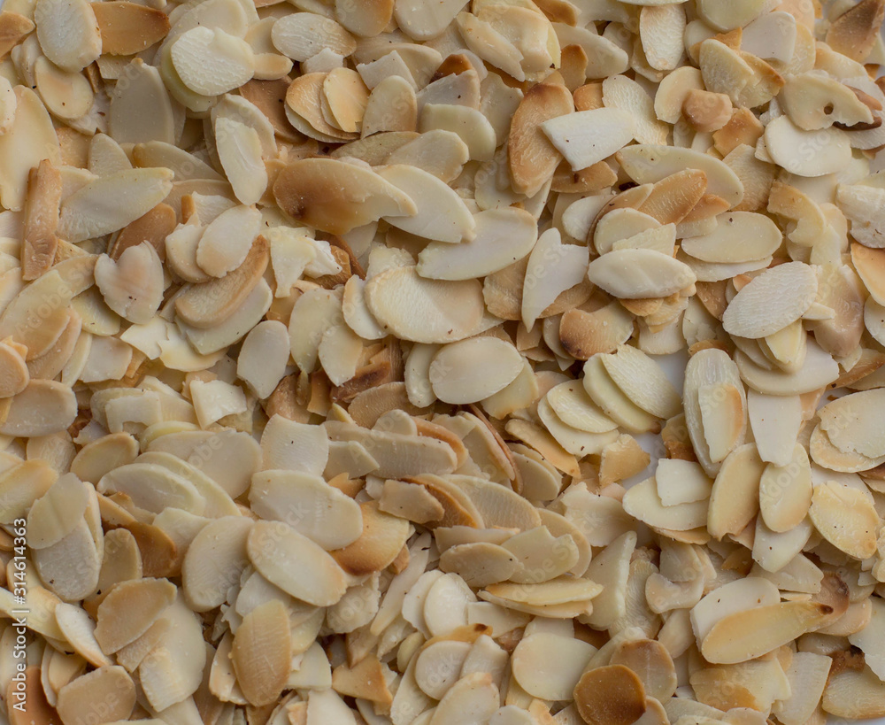 Backed almond slices background. Food texture Backed almond slices background. Food texture