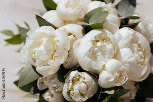 Close-up image of a beautiful and stylish wedding bouquet of white and pink peonies. Summer floral composition.