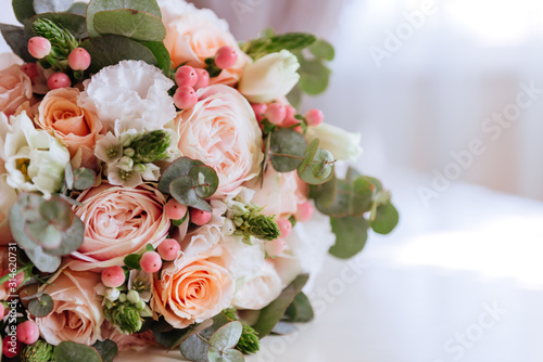 Wedding flowers  bridal bouquet closeup. Decoration made of roses  peonies and decorative plants