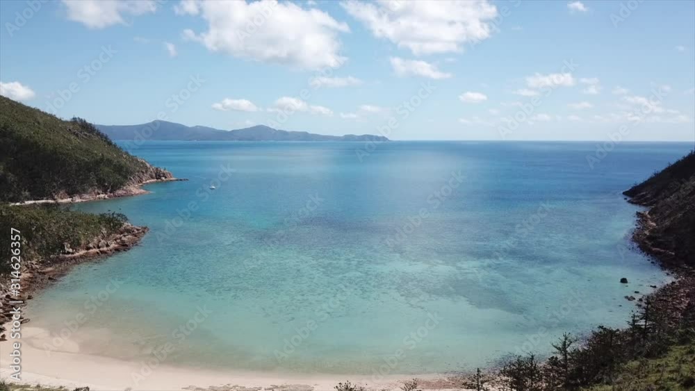Drone flying into tropical lagoon in Whitsudays island australia Drone flying into tropical lagoon in Whitsudays island australia