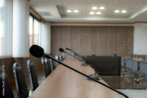 Close up microphone on brown table in meeting room