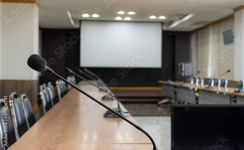 Close up microphone on brown table in meeting room