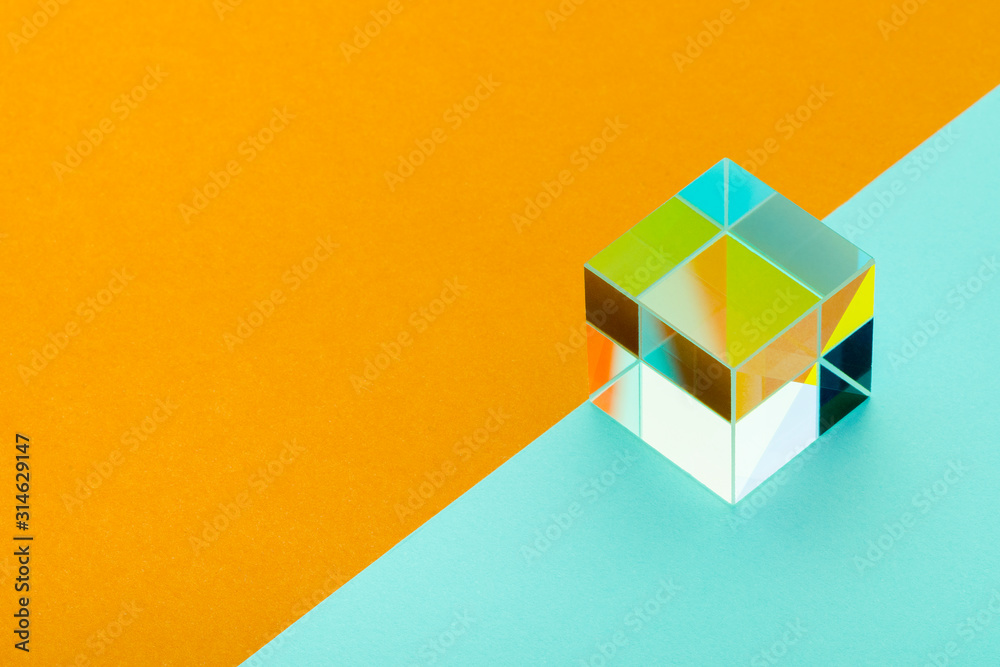 glittering glass cube on an orange and blue background, minimalism, abstraction glittering glass cube on an orange and blue background, minimalism, abstraction