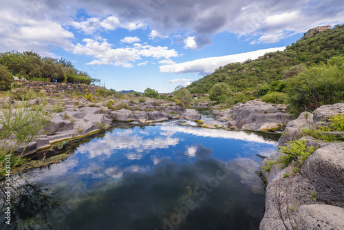 Clouds reflects in waters of Alcantara river on Sicily Island in Italy