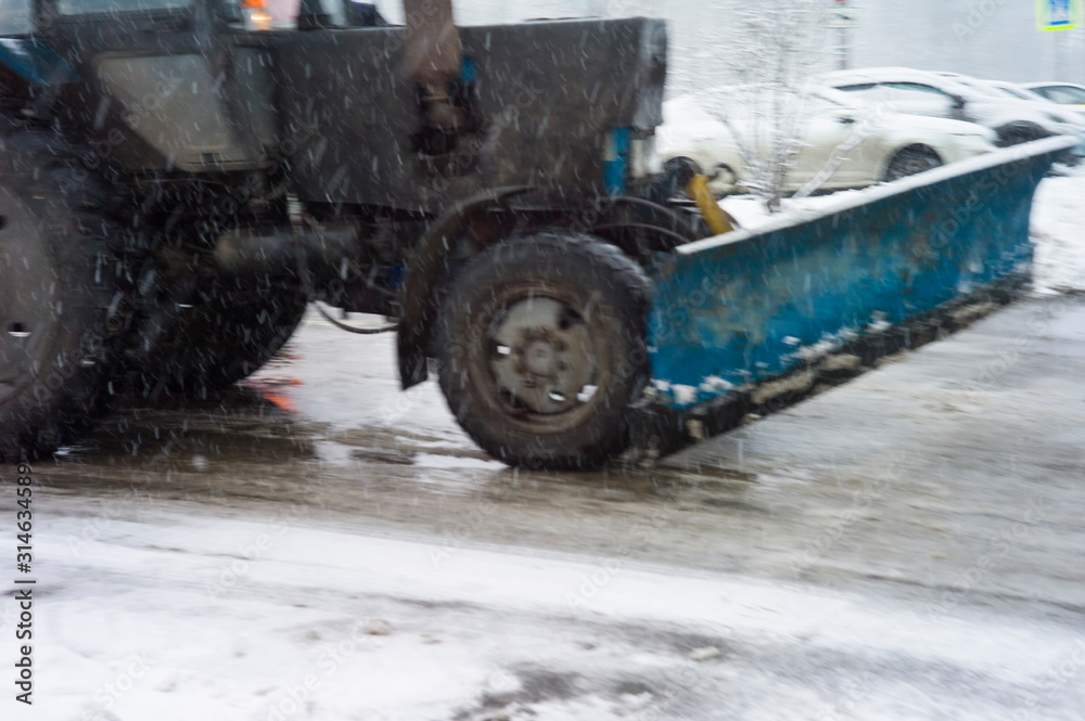 Blurred motion shot of a tractor plowing snow Blurred motion shot of a tractor plowing snow