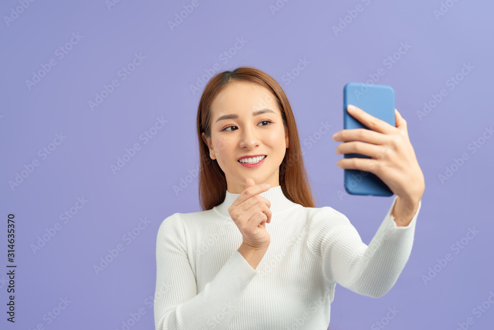 Selfie time. Joyful young women making selfie by her smart phone Selfie time. Joyful young women making selfie by her smart phone
