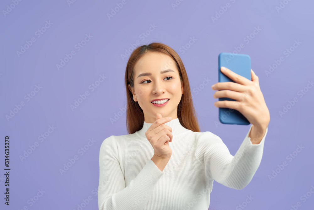 Selfie time. Joyful young women making selfie by her smart phone