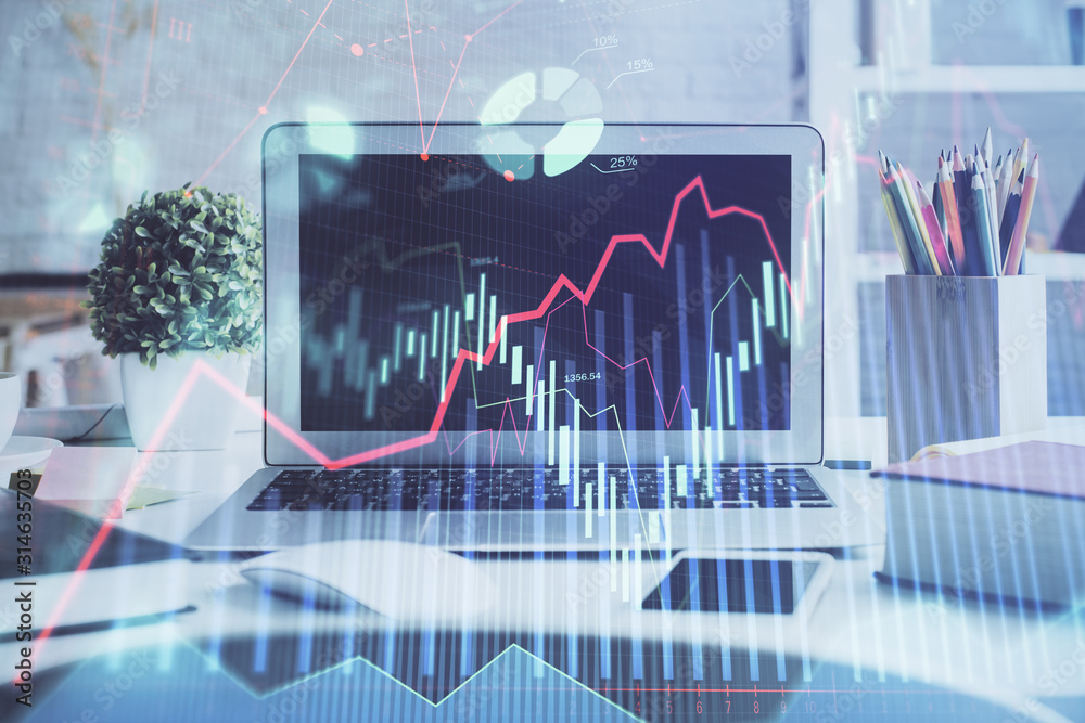 Stock market chart hologram drawn on personal computer background. Double exposure. Concept of investment.