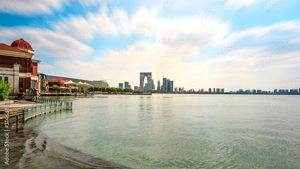 Beautiful city skyline and tranquil lake in Suzhou at sunset