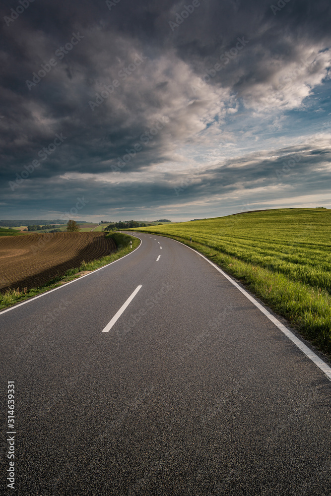 roadtrip with dramatic sky and a unknown destination