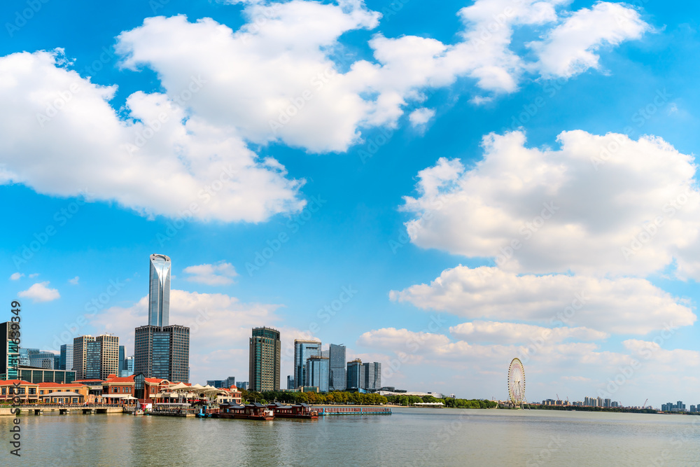 Beautiful city skyline and tranquil lake in Suzhou at sunset