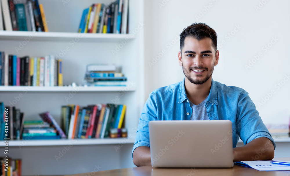 Handsome mexican hipster man working with computer Handsome mexican hipster man working with computer