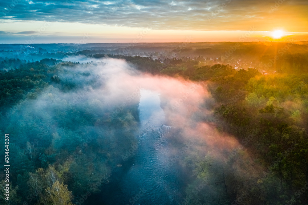 Mist over river at sunrise, view from above