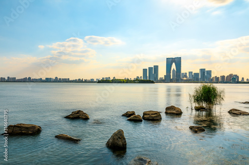Beautiful city skyline and tranquil lake in Suzhou at sunset