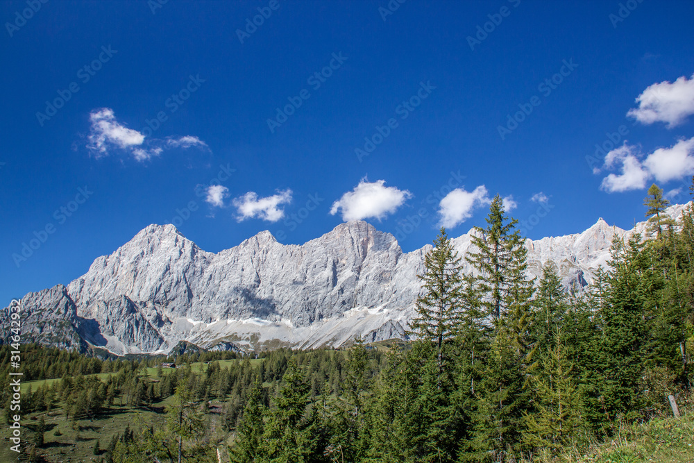 bright blue sky near a glacier in the alps at the dachstein glacier look into a valley of hiking trails