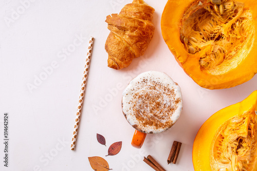 Pumpkin spice latte or coffee in mug. Autumn and winter hot drink on a light background.