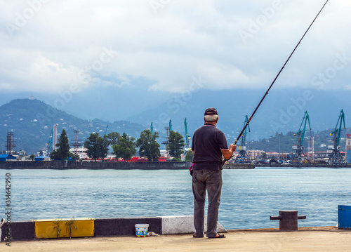 Elderly man fishing in the port of Batumi