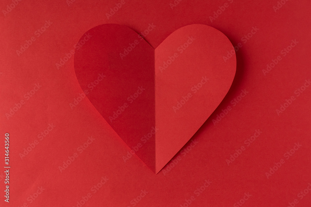 Red paper heart on a red background. Valentine's Day. Valentine's Day. Love and heart..
