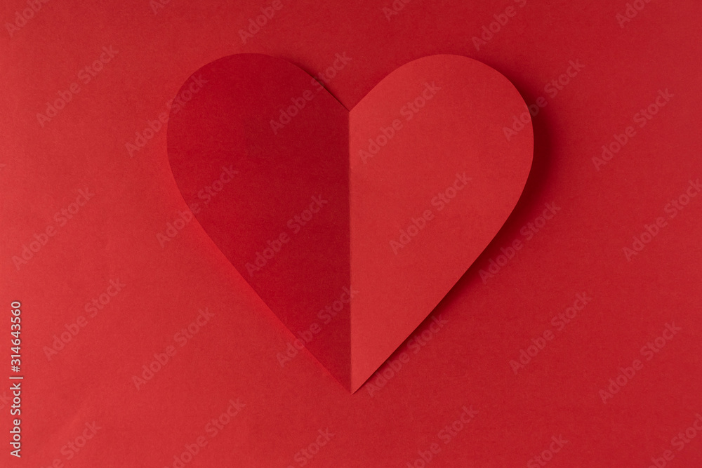 Fototapeta premium Red paper heart on a red background. Valentine's Day. Valentine's Day. Love and heart..