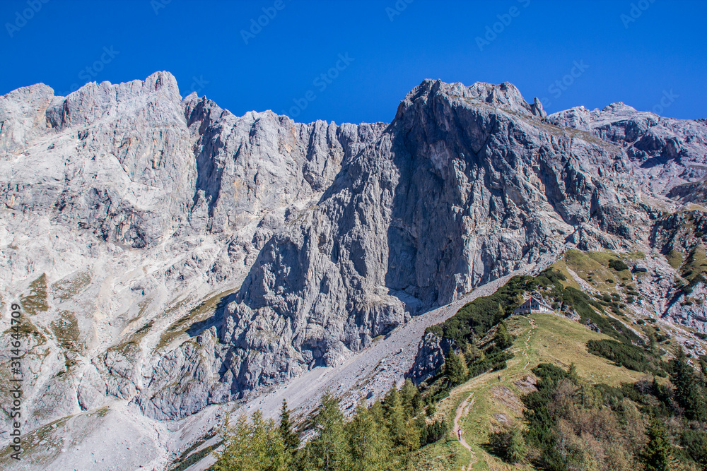 bright blue sky near a glacier in the alps at the dachstein glacier look into a valley of hiking trails