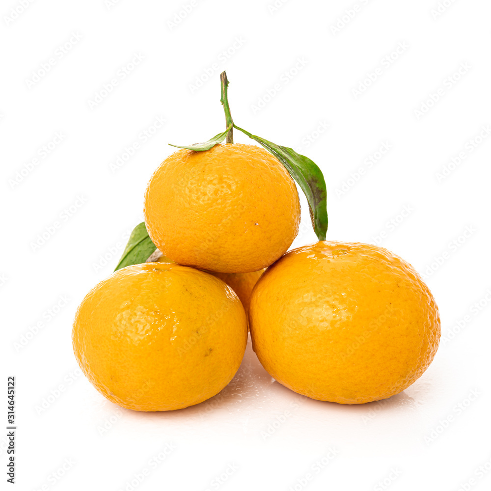 Ripe mandarines with leaves close-up on a white background Ripe mandarines with leaves close-up on a white background