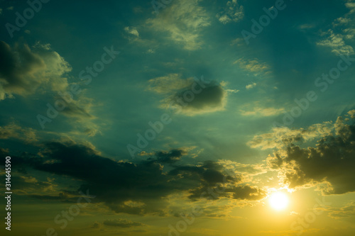 Large heavy clouds slowly float across the blue beautiful sky. Stunning landscape and view. Sky clouds with sunset