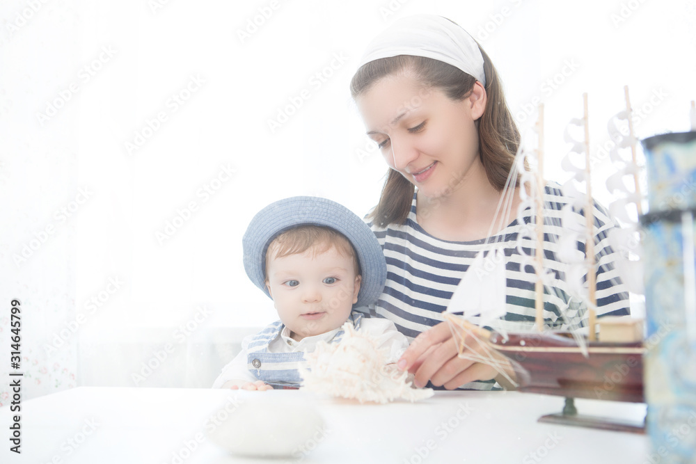 Travel concept. Mother and her baby boy with seashell. Travel concept. Mother and her baby boy with seashell.