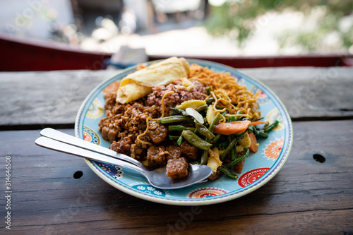 Traditional local balinese street food lunch. Popular balinese meal rice with vegetables and spicy chili sauce photo