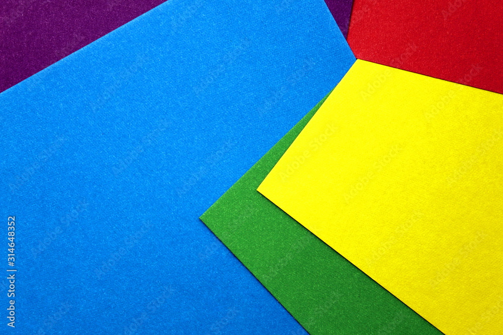 colored cardboard scattered on the table. turned out geometric shapes colored cardboard scattered on the table. turned out geometric shapes