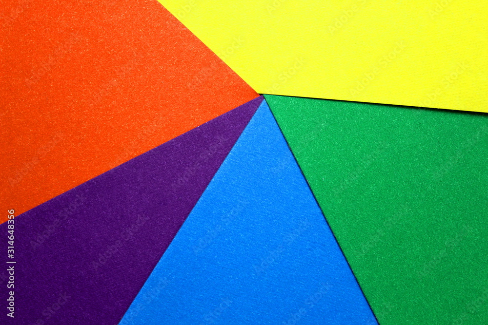 colored cardboard scattered on the table. turned out geometric shapes colored cardboard scattered on the table. turned out geometric shapes