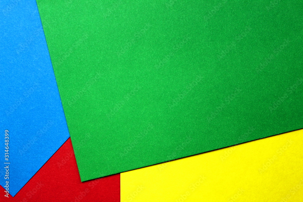 colored cardboard scattered on the table. turned out geometric shapes colored cardboard scattered on the table. turned out geometric shapes