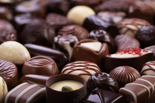 chocolate candies with various fillings, sweet food background.