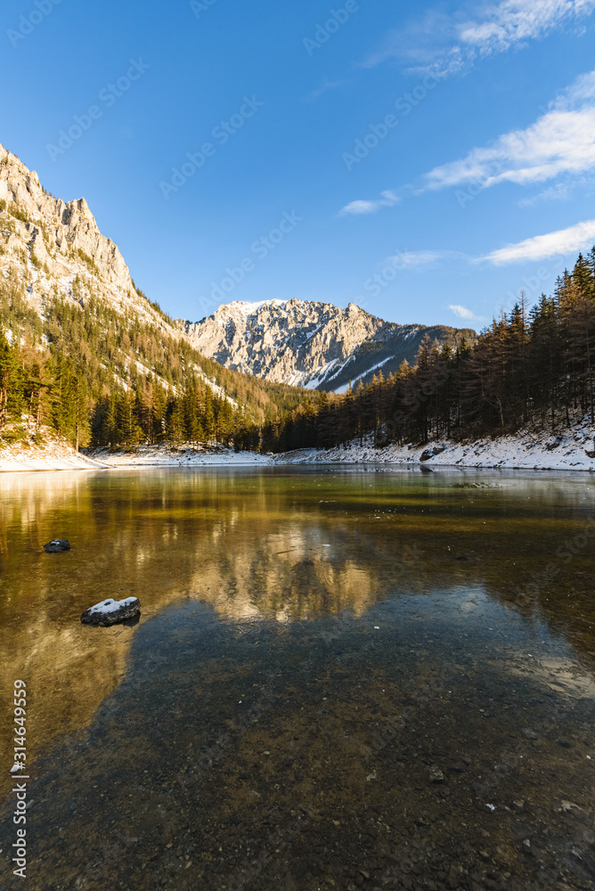 Peaceful mountain view with famous green lake in Austria Styria. Tourist destination lake Gruner See in winter. Travel spot situated in Tragos in lime stone Alps of Hochschwab. Peaceful mountain view with famous green lake in Austria Styria. Tourist destination lake Gruner See in winter. Travel spot situated in Tragos in lime stone Alps of Hochschwab.