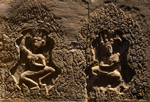 Amazing bas reliefs depicting the beautiful Apsara deva on the wall at Angkor Wat Temple. Location: Angkor Wat Temple, Siem Reap, Cambodia. Artistic picture. Beauty world.