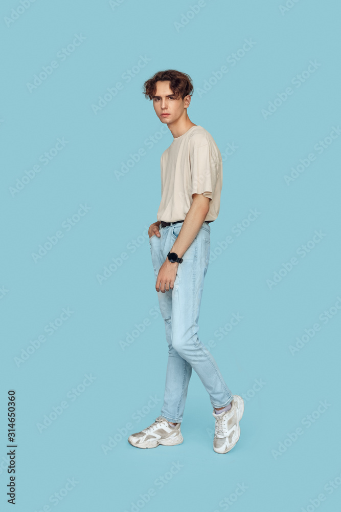 Freestyle. Man standing isolated on gray posing relaxed Freestyle. Man standing isolated on gray posing relaxed