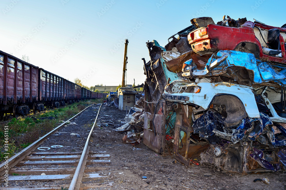 Fototapeta premium The recycling of scrap metal, stacked rows presovanny machines