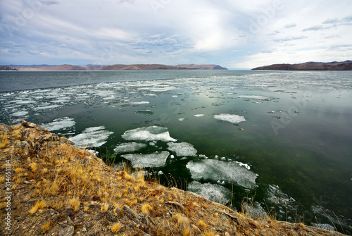 Beautiful spring landscape of Baikal Lake. View of the ice drift in the Olkhon Gate Strait from Cape Ulan