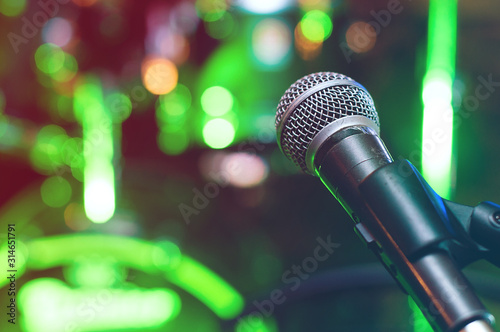 Microphone at concert on green bokeh background