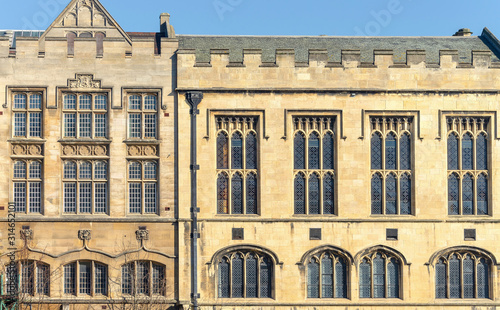 Close-up of the 15th Century Guildhall in York.  The widows are set in into a stone Tudor style building with some ornamentation.