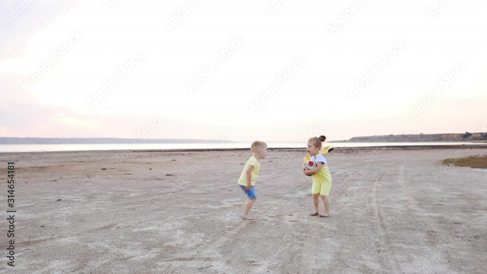 Cute little boy and girl with colorful planes quarrel and runs along sea shore beach slow motion Cute little boy and girl with colorful planes quarrel and runs along sea shore beach slow motion