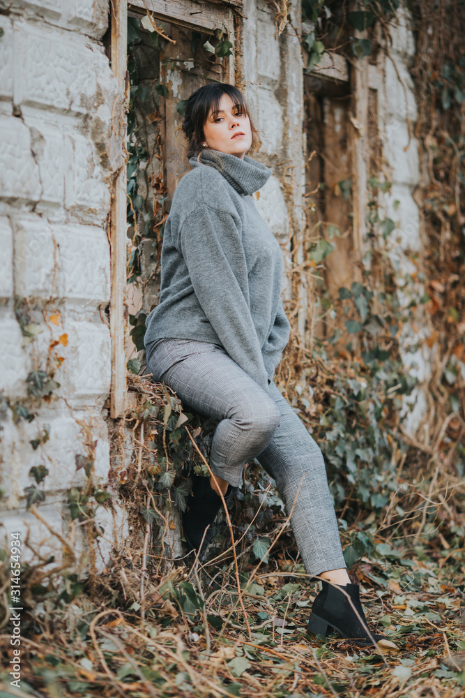 Vertical selective focus shot of a young lady wearing a gray turtleneck sweater Vertical selective focus shot of a young lady wearing a gray turtleneck sweater