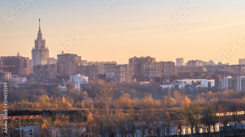 Moscow cityscape with State University and common buildings at autumn sunset.