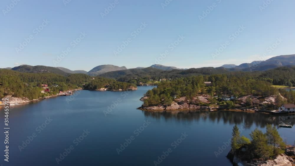 Aerial overflight of beautiful and calm norwegian fiord lanscape with hills in the distance. Aerial overflight of beautiful and calm norwegian fiord lanscape with hills in the distance.