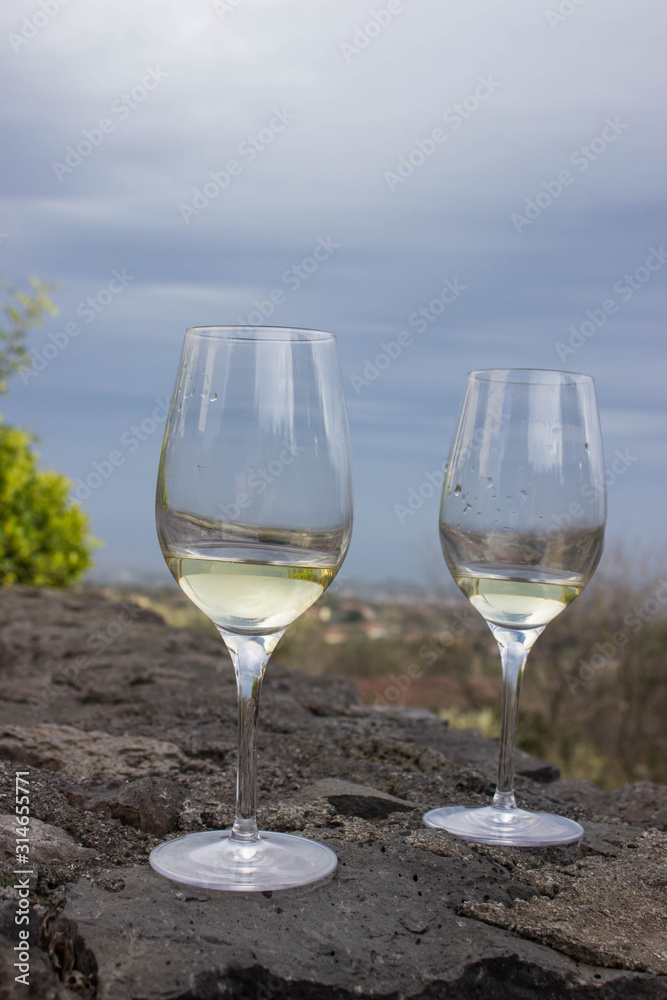 A glass of white wine on the lava stone A glass of white wine on the lava stone