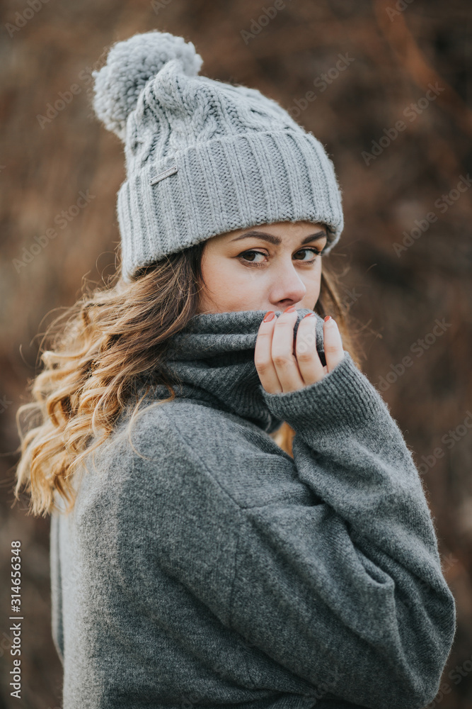 portrait of girl in a grey beanie and sweater