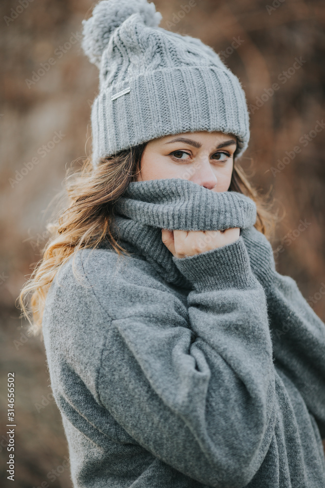 Plakat portrait of girl in a grey beanie and sweater