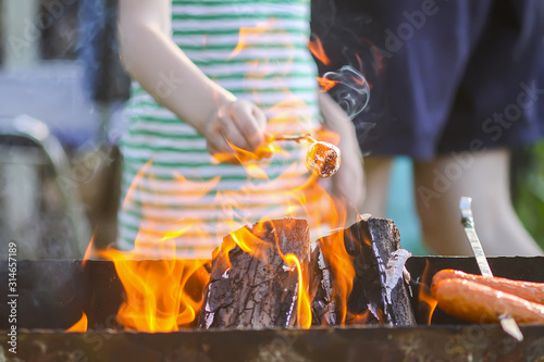 Marshmallow preparing on wooden stick over a brazier