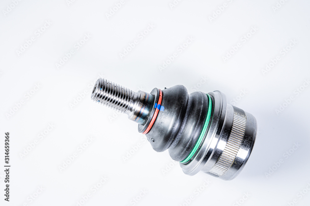 New spare parts spherical ball joints of a suspension bracket of a car on a gray background New spare parts spherical ball joints of a suspension bracket of a car on a gray background