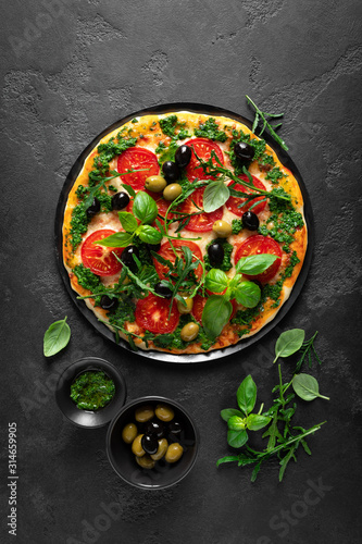 Pizza. Traditional italian pizza with green basil pesto sauce, top view
